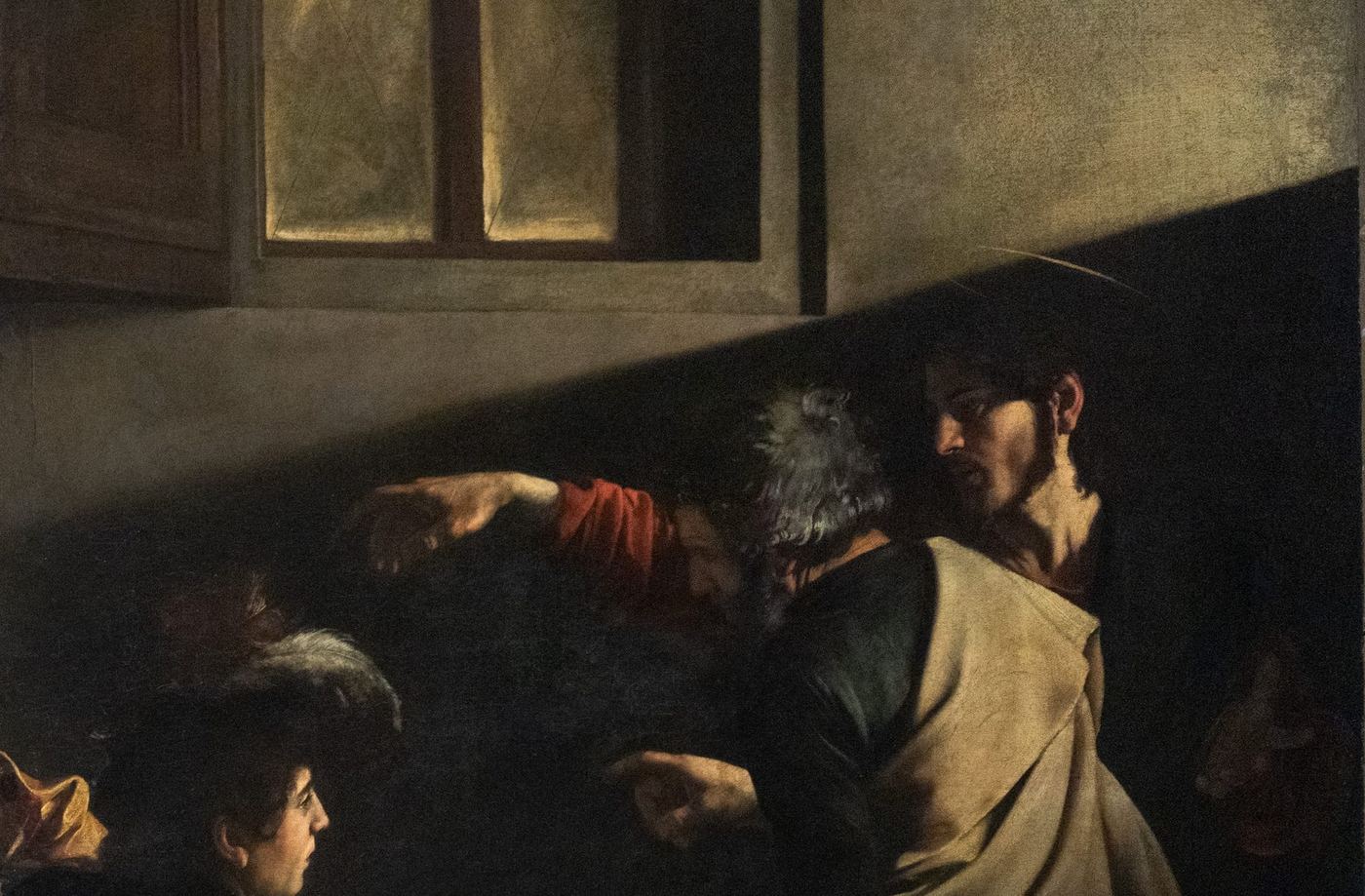 The Calling of Saint Matthew — the hovering hand, and the light from the upper right following the path of the real window